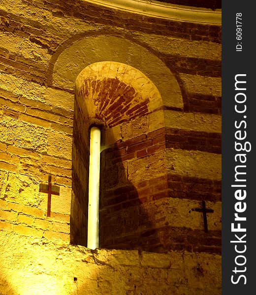 A suggestive shot of a medieval window in Montesiepi hermitage in Tuscany