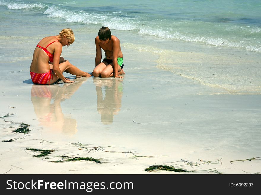 Mother and son exploring the sea.