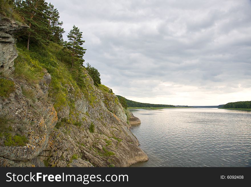 Rocky shore river in cloudy day