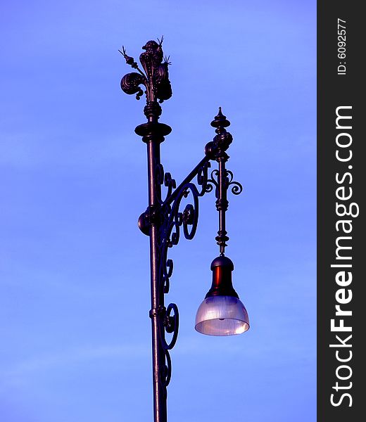 A beautiful whrought iron lamp in riverside od Arno in Florence. A beautiful whrought iron lamp in riverside od Arno in Florence
