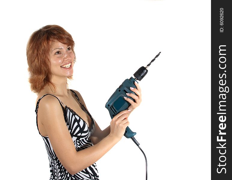 The young girl with a building drill on a white background. The young girl with a building drill on a white background.