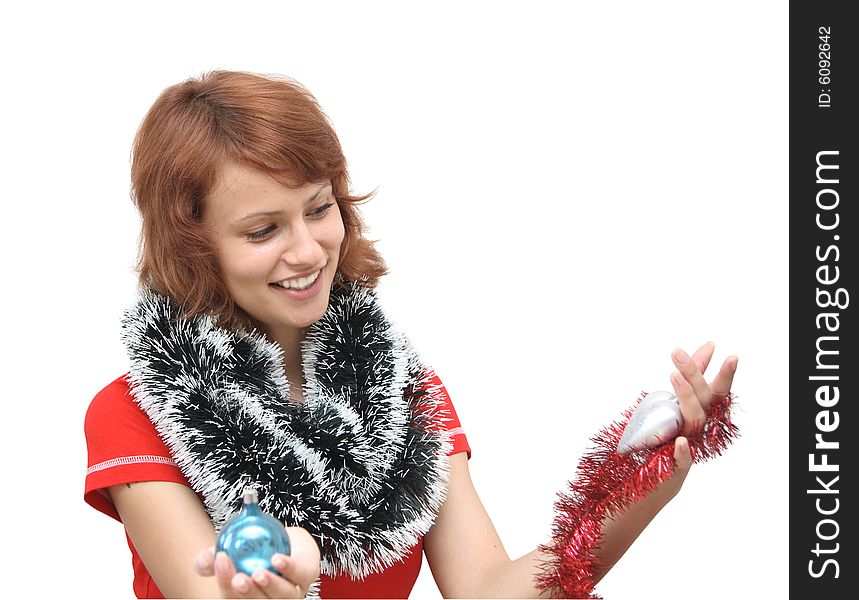 The girl in a red shirt with ornaments for the New Year tree. The girl in a red shirt with ornaments for the New Year tree.