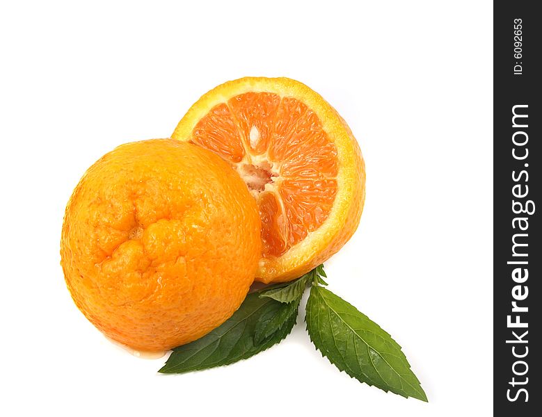 Two half of orange with leaves of mint on a white background.