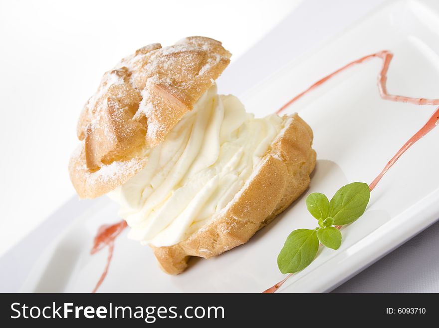 Sweet cookie with cream on plate