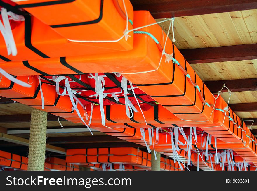 Orange life rafts attached on the sealing of the ship.