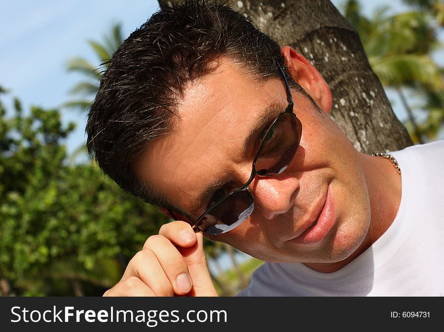 Caucasian male pulling down his sunglasses. Caucasian male pulling down his sunglasses