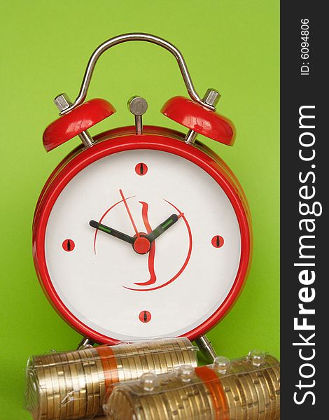 Conceptual photo of clock and coins in green background. Conceptual photo of clock and coins in green background