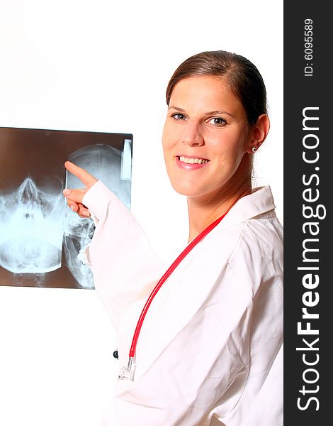 A young female doctor with a x-ray in the background and a stethoscope around the neck!. A young female doctor with a x-ray in the background and a stethoscope around the neck!