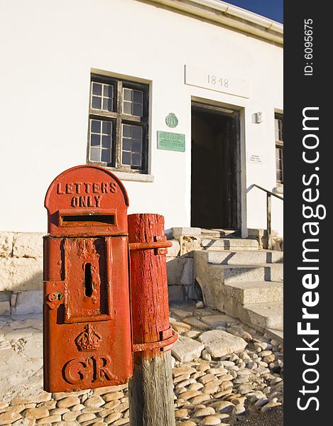 A historical mailbox at the lighthouse in Cape Aghullas, dating back to the 1800's and bearing the crest of King George V of England. Still in use. A historical mailbox at the lighthouse in Cape Aghullas, dating back to the 1800's and bearing the crest of King George V of England. Still in use.