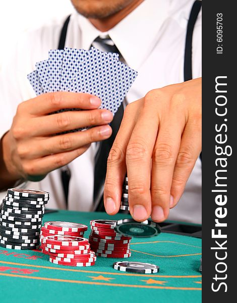 Young man playing poker with a stylish suit. Isolated over white background. Young man playing poker with a stylish suit. Isolated over white background.