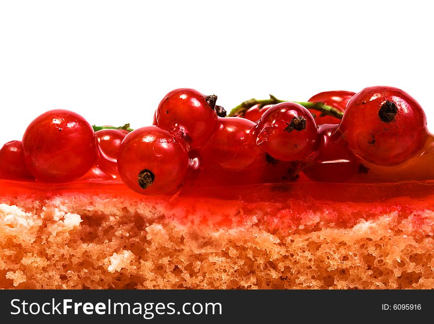 Red currant on a celebratory pie on a white background