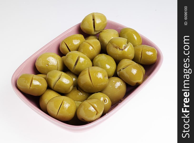 Green olives with cup on the white background.