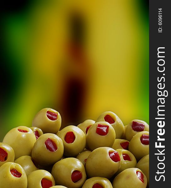 Green olives on the colourful background. . Green olives on the colourful background.