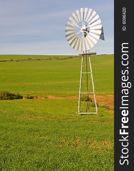 Traditional windmill in a green pasture