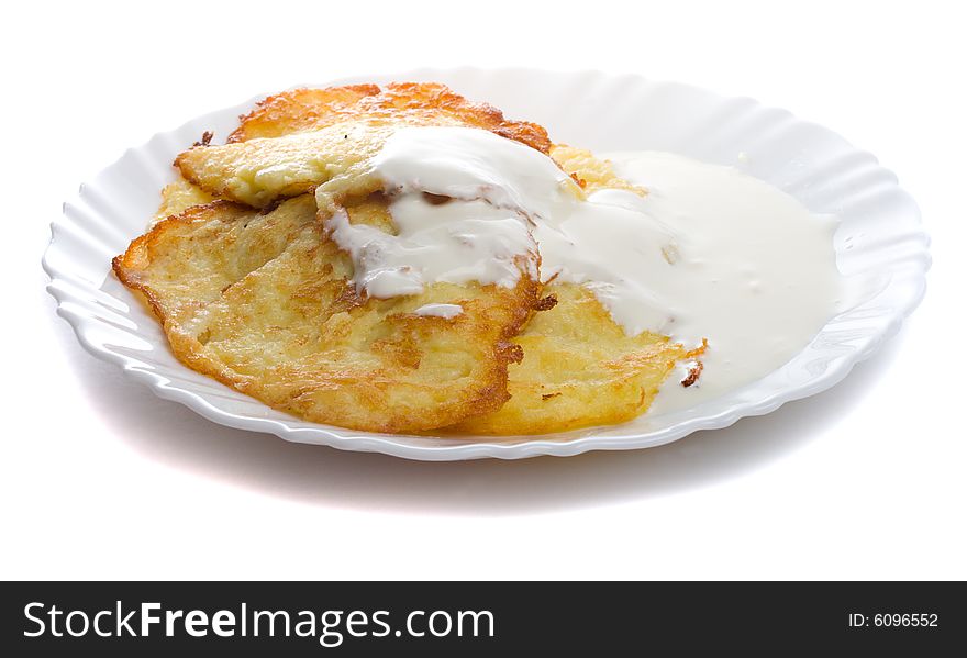 Close-up pancake from marrow and lure on plate, isolated over white background