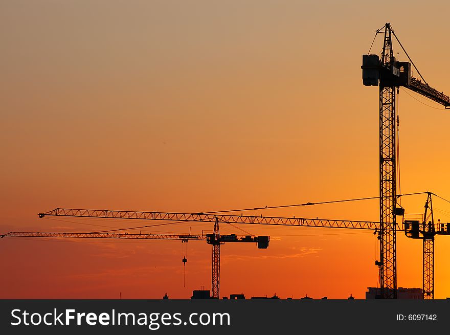Construction site - cranes at dawn (horizontal version)