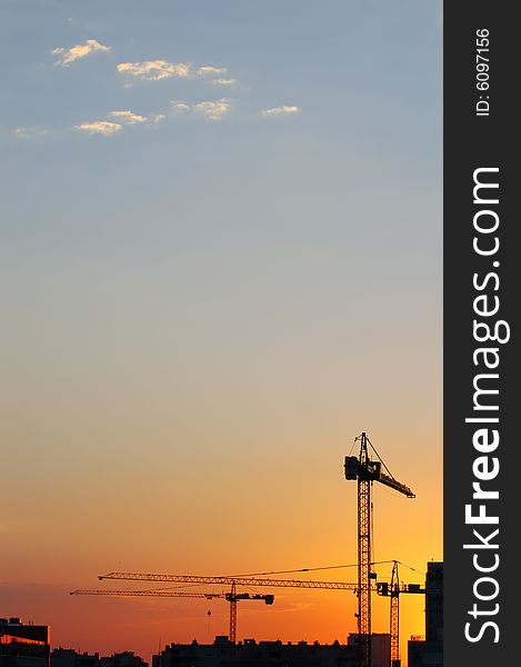 Construction site - cranes at dawn (vertical version)