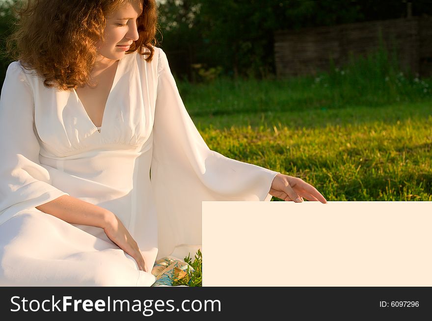 Girl sitting on green grass