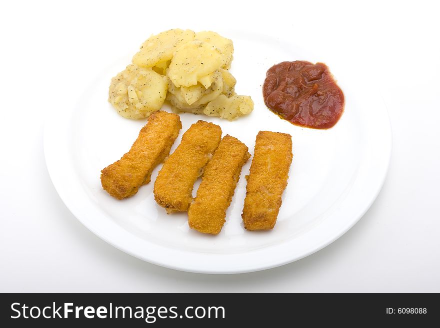 Fish fingers with potatoe salad on a white plate