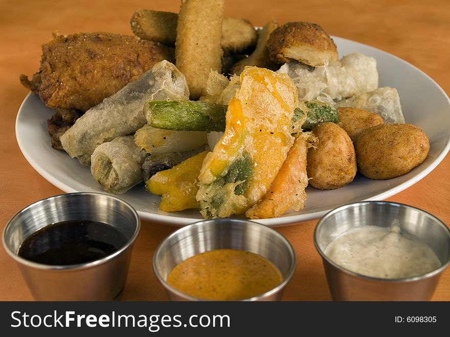 Vegetarian appetizer platter with dipping sauces