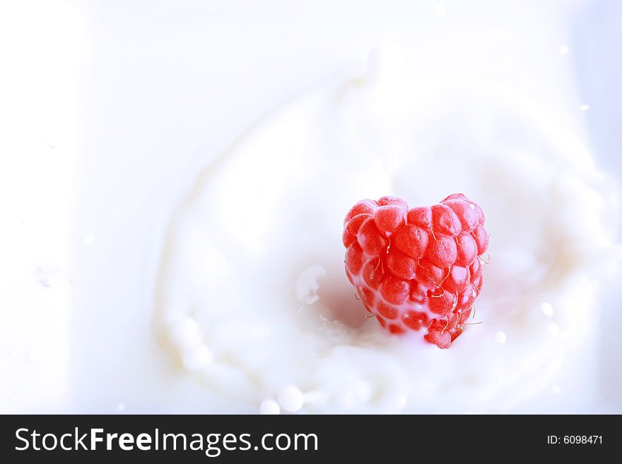 Raspberry splashing in fresh milk, great concept for freshness. Raspberry splashing in fresh milk, great concept for freshness