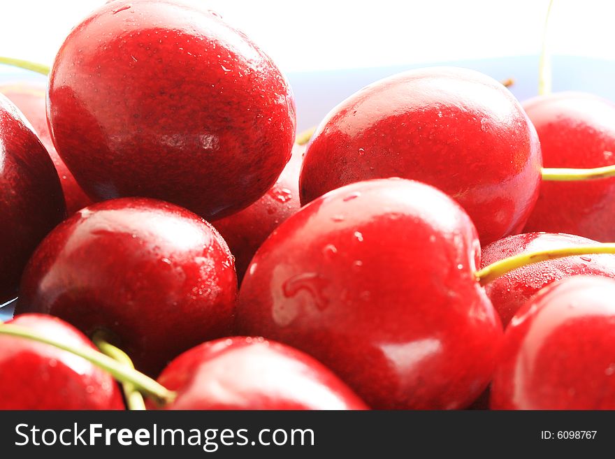 Fresh red cherries in a bowl, high key lighting