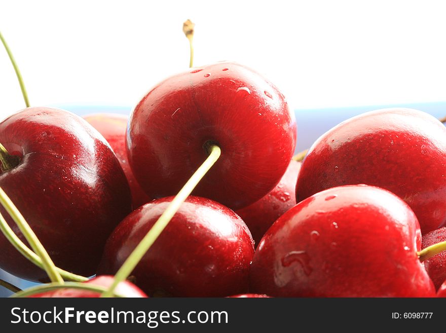 Bowl of fresh cherries, high key lighting from behind. Bowl of fresh cherries, high key lighting from behind