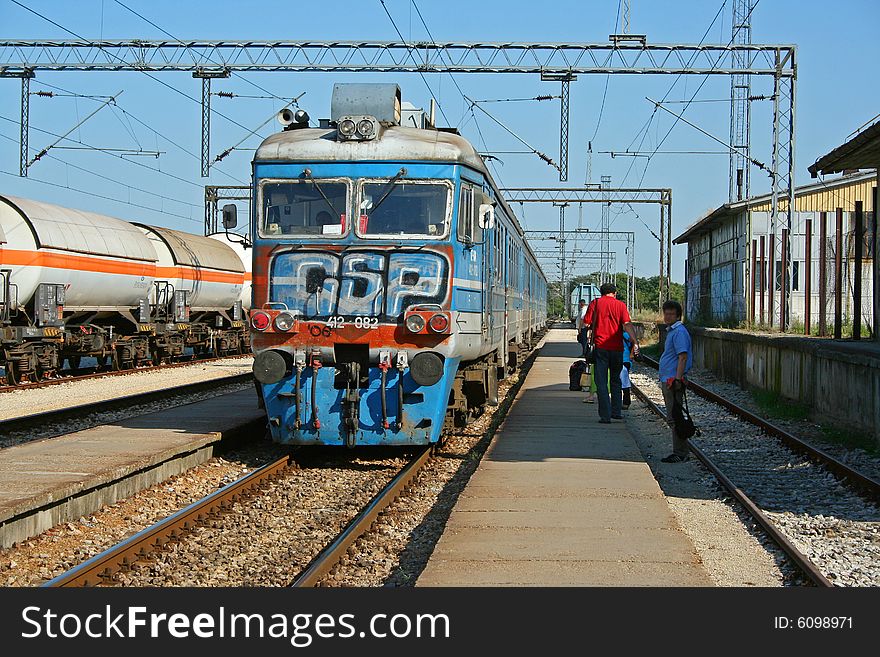 Passenger train enter in small station.