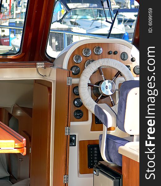 Motor boat wheel and stylish control panel close up.