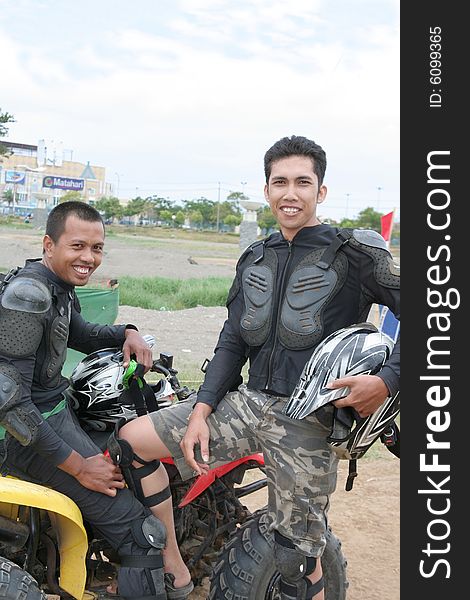 Two Man in racing costume with atv or quad bike vehicle. Two Man in racing costume with atv or quad bike vehicle