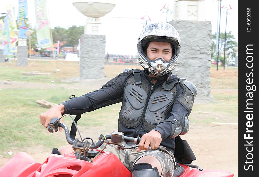 Man in racing costume with atv or quad bike vehicle. Man in racing costume with atv or quad bike vehicle