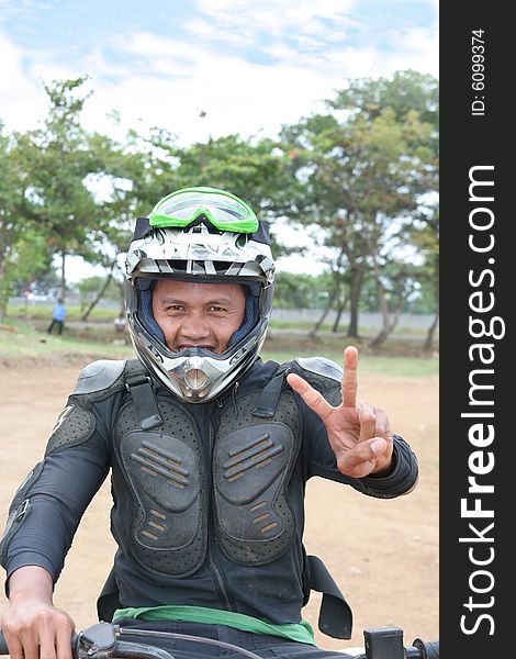 racing winner victory, Man in motocross racing costume in field