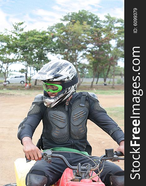 Man in racing costume with atv or quad bike vehicle. Man in racing costume with atv or quad bike vehicle