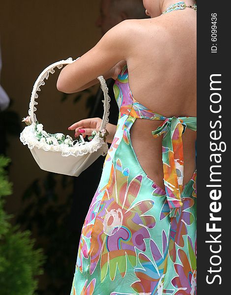 A lady with a basket full off flowers