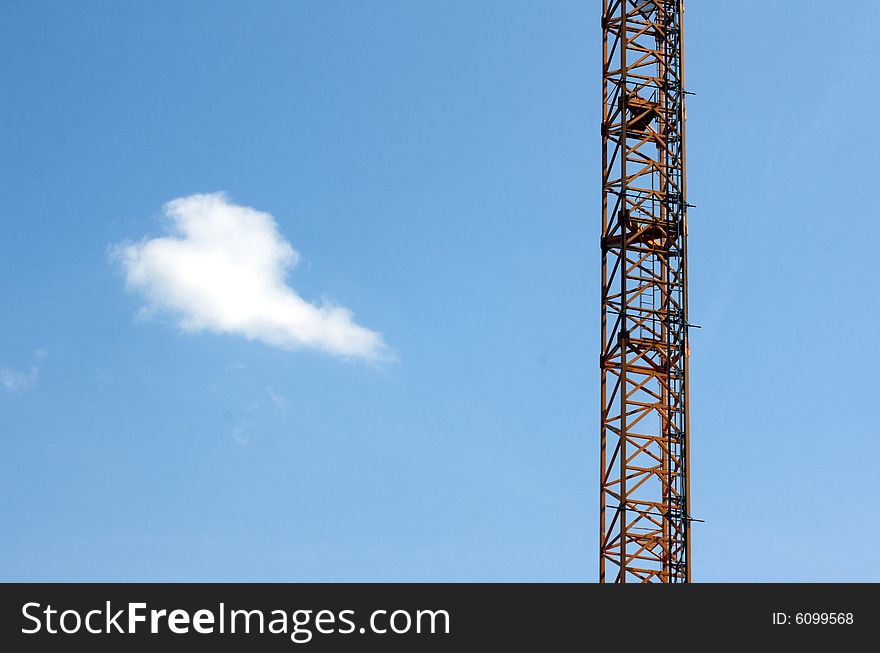 Construction crane with blue sky and cloud