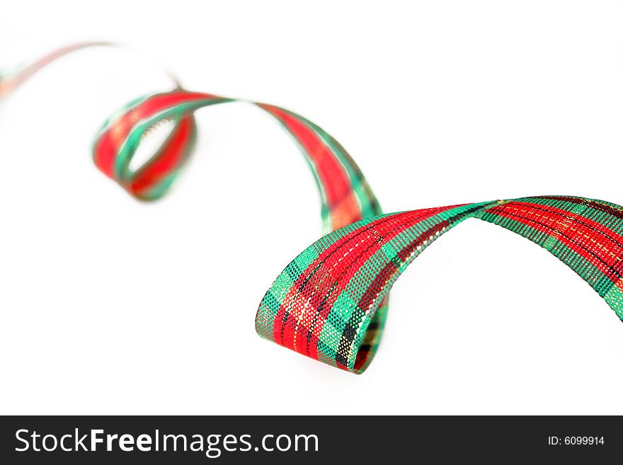 Ribbon with Christmas colors isolated on a white background. Used shallow depth of field and selective focus. Ribbon with Christmas colors isolated on a white background. Used shallow depth of field and selective focus.