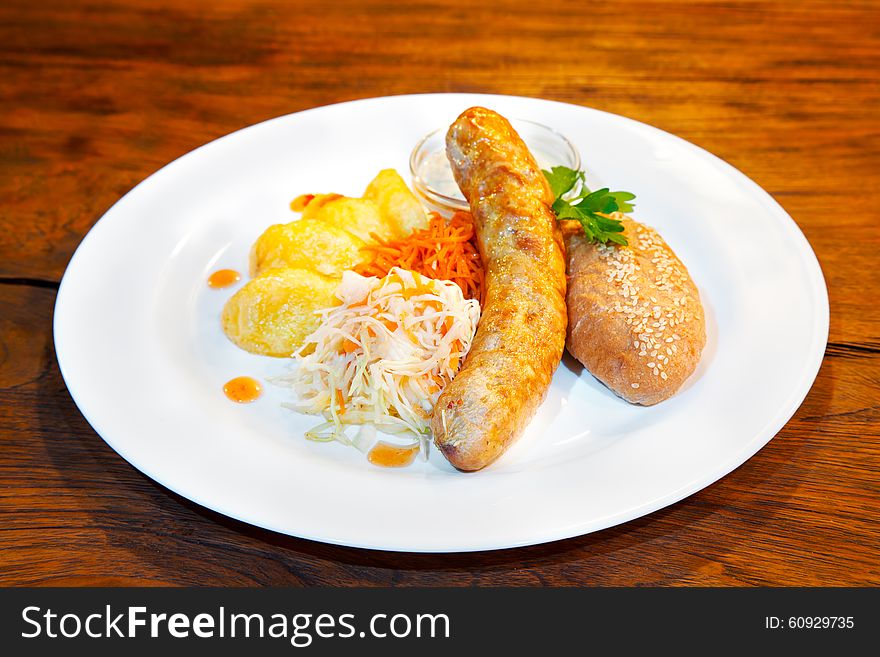 Fresh sausages with vegetables on a plate