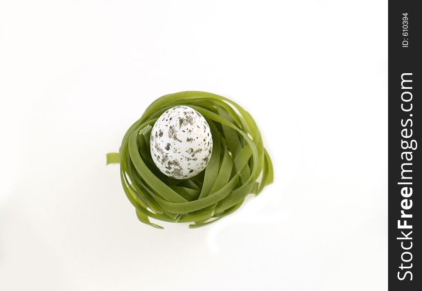 Green pasta nest with egg, white background. Green pasta nest with egg, white background