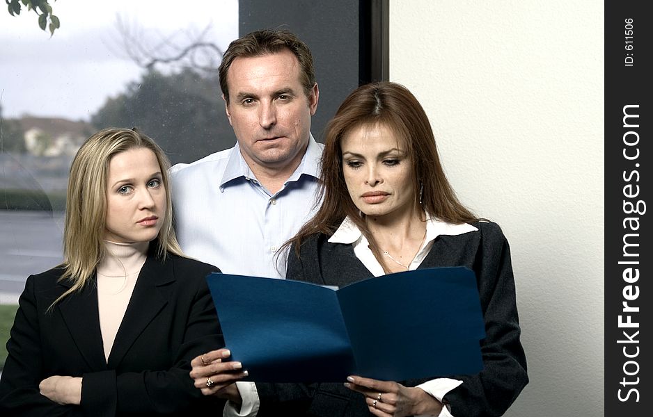 Members of a business team with strong, confident expressions on their faces - front view. Members of a business team with strong, confident expressions on their faces - front view