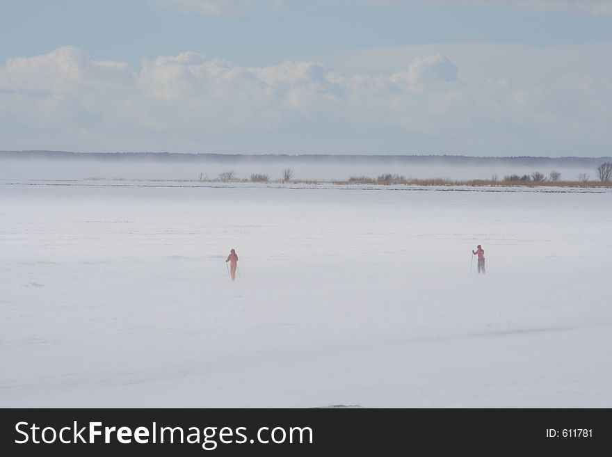 People skiing on a frozen sea. People skiing on a frozen sea