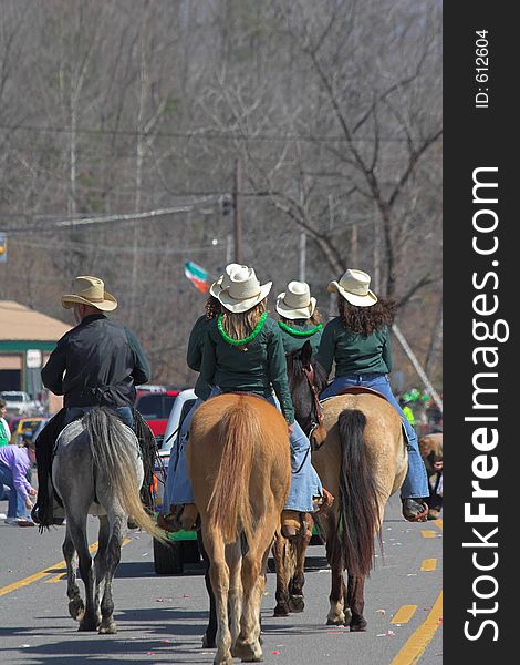 Cowboys & cowgirls riding horses with a wagon train thru town. Cowboys & cowgirls riding horses with a wagon train thru town