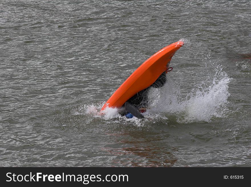 Lone kayaker practicing recovery from roll over. Lone kayaker practicing recovery from roll over