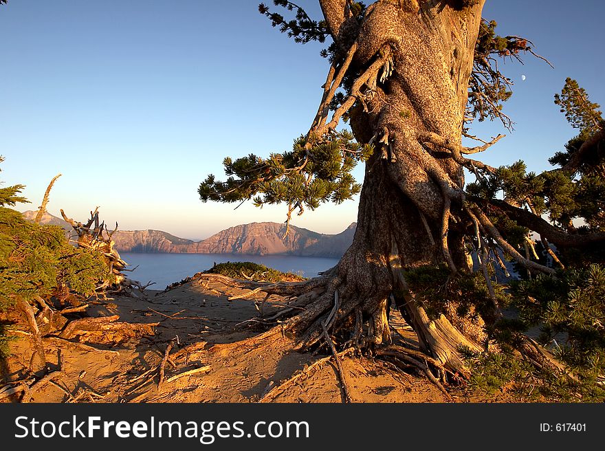 Sun setting over the Crater Lake National Park with the moon in the background. Sun setting over the Crater Lake National Park with the moon in the background.