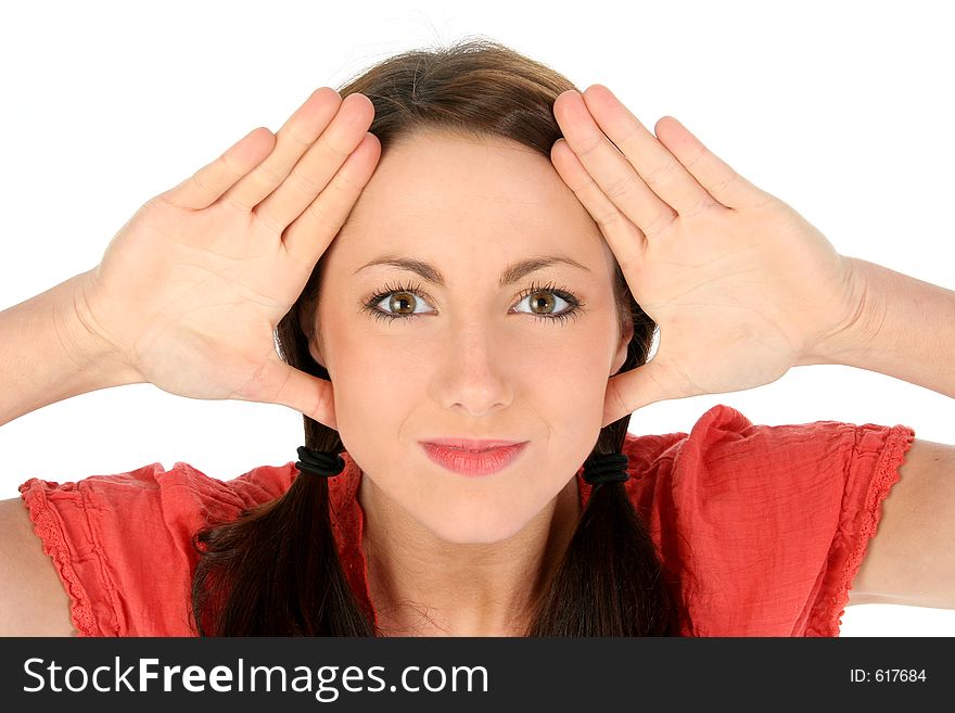 Beautiful young brunette woman framing face with hands.