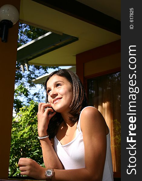 Young woman speaking by phone. Young woman speaking by phone