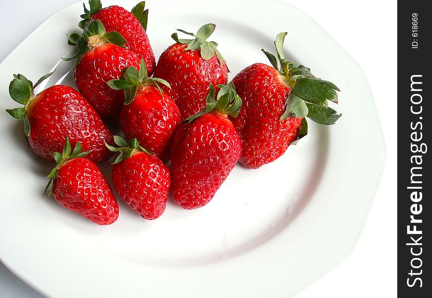 Strawberries over white