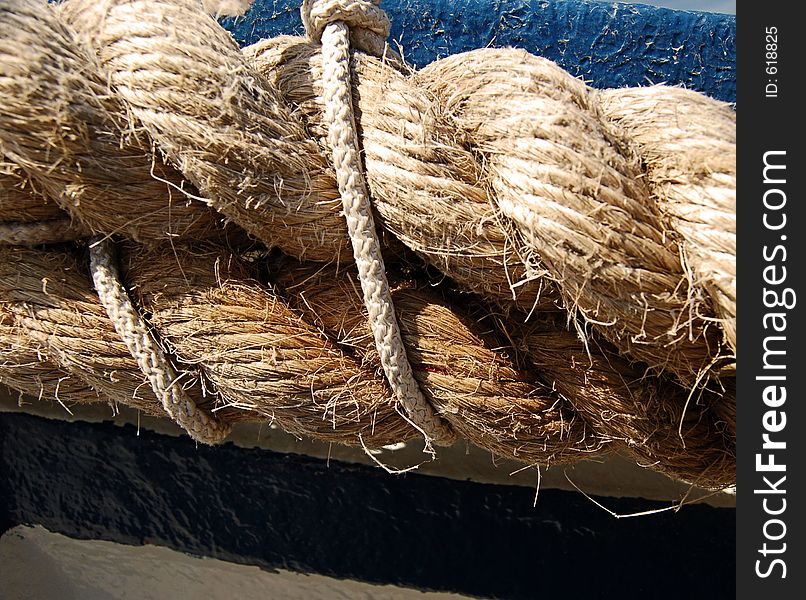 A close up of a rope holding two stronger ones across the stem of a typical sicilian boat in Syracuse. A close up of a rope holding two stronger ones across the stem of a typical sicilian boat in Syracuse.