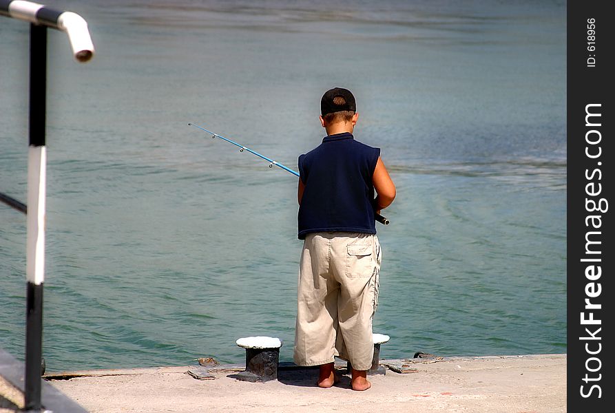 The small fisherman at edge of a pier