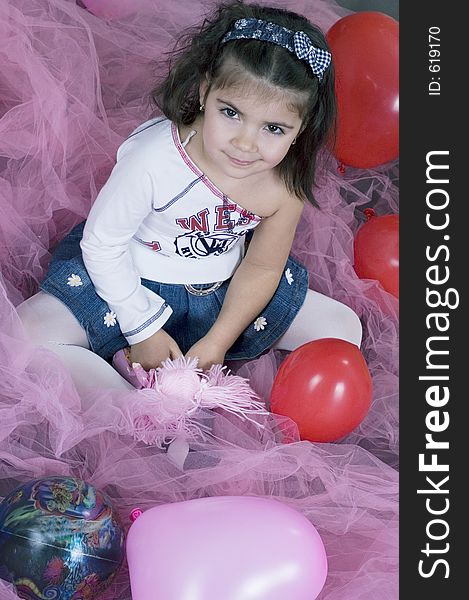 Little pretty girl in the middle of balloon and pink veils. Little pretty girl in the middle of balloon and pink veils