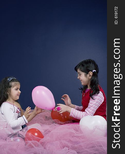 Young and beautiful girls playing with balloons